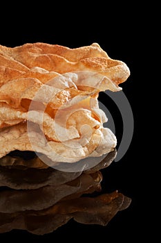 Pappadum stack on black.