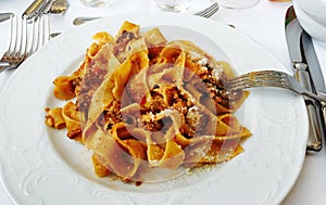 Pappardelle al ragÃ¹ with parmesan, traditional italian food