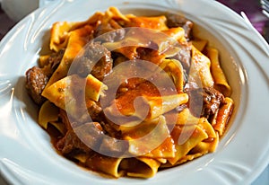 Pappardelle with boar ragu. Tuscan typical recipe. photo