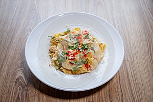 Pappardelle pasta italian with tomatoes, parmegiano reggiano cheese top angle detail