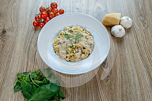 Pappardelle prosciutto e funghi pasta with wild garlic to garnish