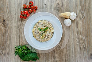 Pappardelle prosciutto e funghi pasta with wild garlic to garnish top