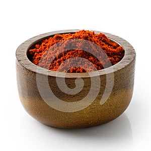 Paprika in dark wood bowl.