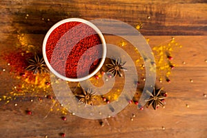 Paprika powder in wooden bowl with anise