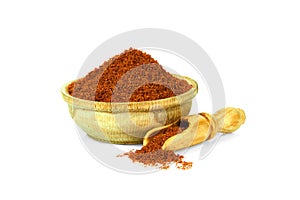 Paprika in a wooden cup with a spoon for spices isolated on a white background. Collection of spices and herbs