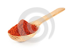 Paprika on a wooden spoon isolated on white background