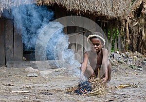 Papuan boy making fire, Wamena, Papua, Indonesia