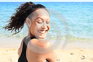 Papuan girl on beach by sea