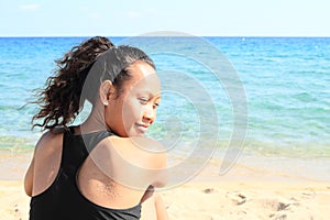 Papuan girl on beach by sea
