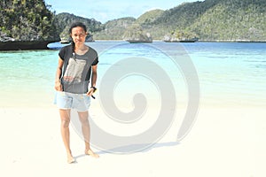 Papuan girl on beach in Wayag