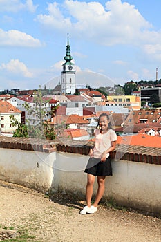 Papuan girl with City tower in Trebic behind