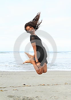 Papuan girl jumping on beach