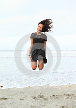 Papuan girl jumping on beach