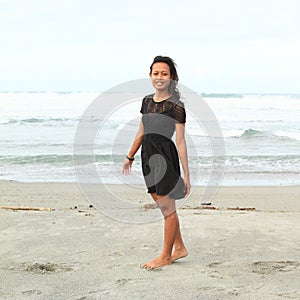 Papuan girl walking on beach