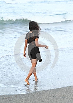 Papuan girl walking in sea