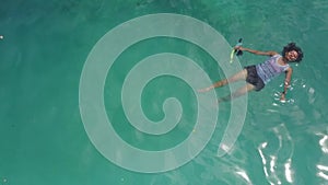 Papuan woman swimming in tropical sea