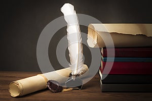 Papyrus scrolls on a table top with books, pen and inkwell