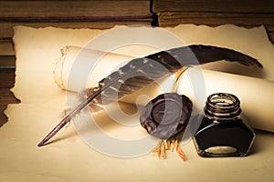 Papyrus scrolls on a table top with books, pen and inkwell