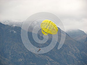 Para-sailing is floating in the sky.