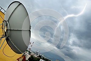 Parabolic antenna and lightning photo