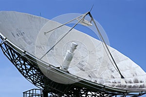 Parabolic satellite dish receiver over blue sky