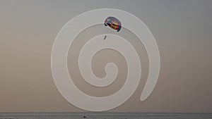 Parachute activity at tropical beach at sunset. Calm sea waters and. Beach recreations with parachute. Towing a