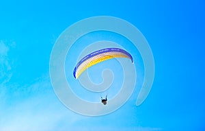 Parachute against the blue sky