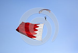 Parachute display team performs before cricket festival at Isa Town, Bahr