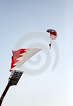 Parachute display team performs before cricket festival at Isa Town, Bahr