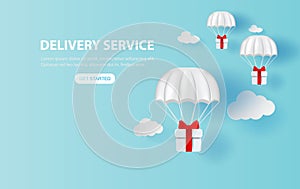 Parachute gift box floating on smartphone.Delivery service app with Gift Box on air.Happy new years and merry Christmas banner.