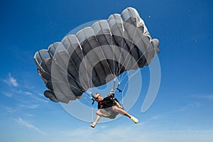 Parachute in the sky. Skydiver is flying a parachute in the blue sky.