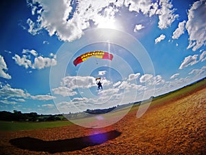 Parachute tandem landing with lens flare