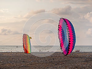 Parachutes on the ground. Wind. Kite Festival. Different kites in the sky. Vacation at the resort