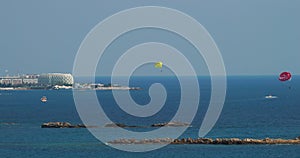 Parachuting In Turkey. Time-lapse Yellow Parasail Wing Pulled By Red Boat. Sea Summer Recreation. Parasailing With Boat