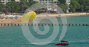 Parachuting In Turkey. Yellow Parasail Wing Pulled By Boat. Sea Summer Recreation. Parasailing With Boat Over Sea In