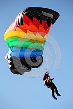 Parachutist with colorful parachute photo