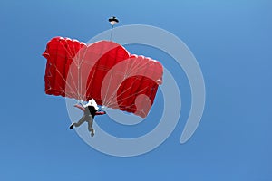 Parachutist with red parachute