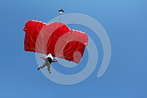 Parachutist with red parachute photo