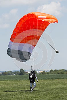 Parachutist running after landing in a field