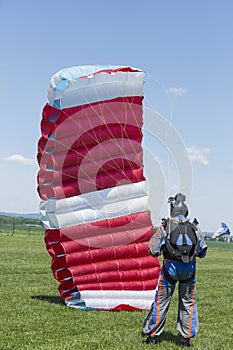 Parachutist running after landing in a field