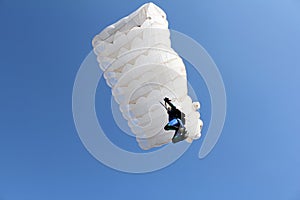 Parachutist with white parachute photo