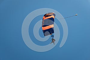 Parachutists in the blue sky
