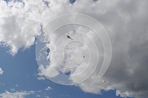 parachutists with helicopter in a sky