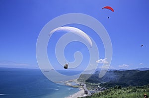 Parachutists over beach