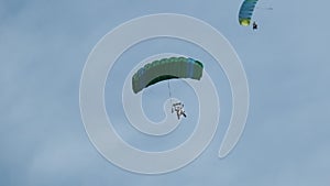 Parachutists in Tandem Flying in the Sky with a Parachute. Slow Motion