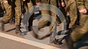 Parade of military women and men legs in the frame marching