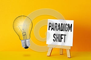 Paradigm Shift is shown using the text and photo of light bulb
