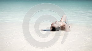 Paradisaic delight. Girl sexy bikini lay relaxing turquoise ocean water lagoon. Woman on vacation relaxing in paradisiac