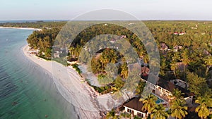 Paradise Coast Resort with Palm Trees and Hotels by Ocean, Zanzibar, Aerial view