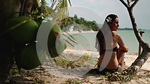 Paradise, Thai resort: woman admires of tropic seascape. Back view shot of young lady at sandy beach